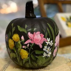 a painted pumpkin sitting on top of a table