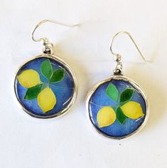 Just in time for Spring, these Lemon Cloisonne earrings were hand crafted in the USA using silver wire on fine silver and multiple layers of vitreous enamels, with each layer applied by hand and fired in a kiln. The finished cloisonne pieces are set in sterling silver with sterling silver ear wires. Nickel-free Enamel Drop Earrings, Enamel Drop Earrings With Ear Wire, Artistic Enamel Jewelry With Earrings, Artistic Enamel Jewelry With Matching Earrings, Artistic Round Enamel Jewelry, Artistic Enamel Earrings Nickel-free, Hand Painted Sterling Silver Earrings For Gift, Hand Painted Sterling Silver Dangle Jewelry, Hand Painted Silver Dangle Jewelry