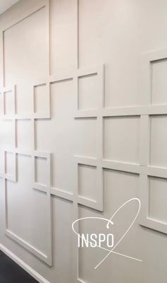 the inside of an office with white walls and black flooring, in front of a logo that reads inspo