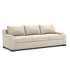 a white couch with four pillows on it