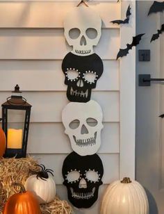 halloween decorations with skulls and pumpkins on the front porch