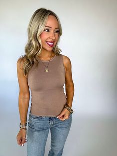 Stay comfy and chic in our Essential Ease Sleeveless Top! Made with soft and stretchy fabric, this tank features a round neck and a slim, fitted fit for ultimate comfort. Perfect for everyday wear! We love this top worn on itsit'sown or layered under your favorite jacket or cardigan. Runs true to size. Fabric is stretchy but not overly stretchy. S/M fits like an XS/S Randee is wearing size small/medium. 95% Viscose 5% Nylon Chic Tank Strap Tops For Everyday, Chic Tops With Tank Straps For Everyday, Chic Everyday Tank Top With Tank Straps, Chic Camisole Tank Top For Everyday, Chic Everyday Camisole Tank Top, Chic Everyday Tank Top, Brown Stretch Cami Tank Top, Chic Stretch Camisole For Everyday, Chic Seamless Tank Top For Everyday