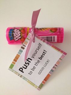 two candy bars tied to each other with a pink ribbon and tag that says push yourself