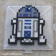 a lego star wars character made out of black and white beads on a clear plastic tray