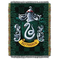 a green and white throw with the sly crest on it's front, surrounded by snakes