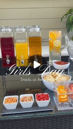 a table topped with lots of different types of drinks and snacks on top of it