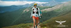 a woman hiking up a trail in the mountains