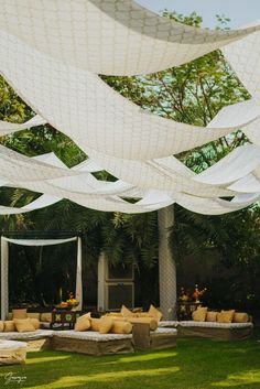 an outdoor seating area with white fabric draped over it