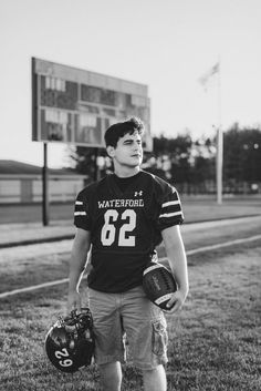 a young man wearing a football uniform and holding a catchers mitt