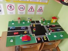 a child's play table with cars and buildings on it