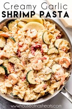 creamy garlic shrimp pasta in a skillet with zucchini