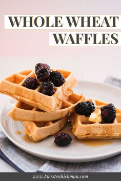 three waffles on a plate with syrup and berries