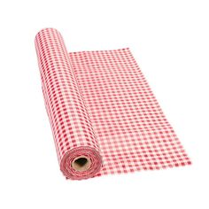 a red and white checkered table cloth rolled up on top of a roll of paper