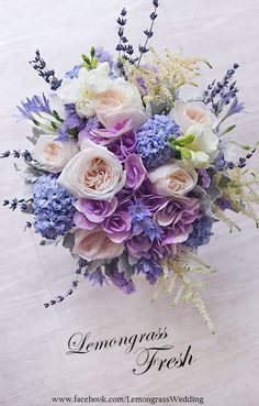 a bouquet of purple and white flowers on a table