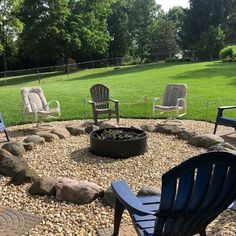 a fire pit surrounded by chairs and rocks