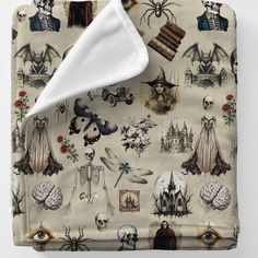 an image of a blanket with many different things on it, including skulls and skeletons