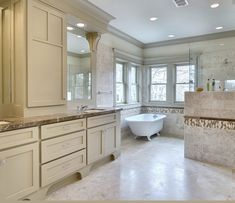 a large bathroom with two sinks and a bathtub next to a window in the corner