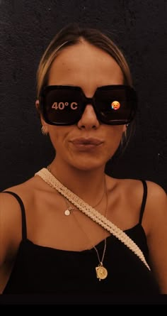 a woman wearing glasses with the words 40 o'clock on it, in front of her face