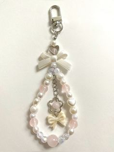 a key chain with pearls and bows on it