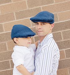 a man holding a little boy wearing a blue hat