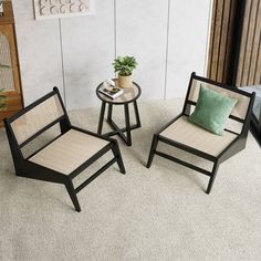 two chairs and a table with a plant on it in a living room next to a window