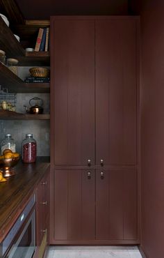 an image of a kitchen with wooden cabinets and wood counter tops on the left side