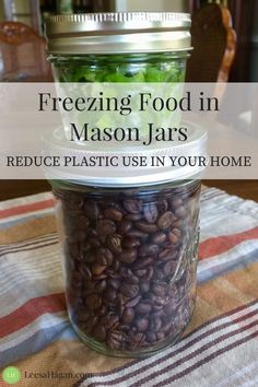 a mason jar filled with coffee beans sitting on top of a table