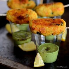 small cups filled with food sitting on top of a table