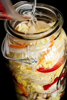 a glass jar filled with food on top of a table