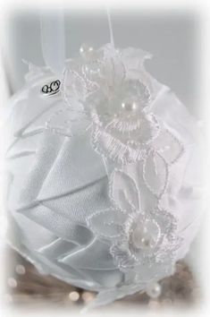 a white hat with flowers and pearls on it