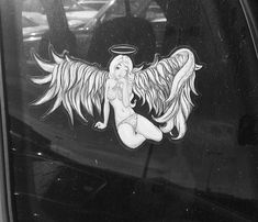 an angel sticker on the side of a car with wings and a halo above her head