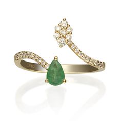 an emerald and diamond ring with two diamonds on the band, set in 18k yellow gold