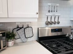 a kitchen with pots and pans hanging on the wall next to an oven top