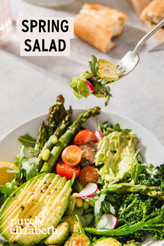 a white plate topped with vegetables and bread