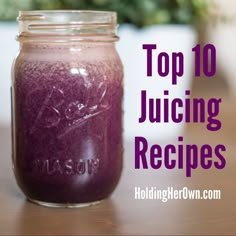 a jar filled with purple liquid sitting on top of a wooden table