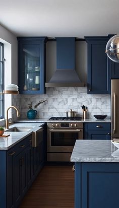 a kitchen with blue cabinets and stainless steel appliances