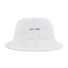 First, it protected fishermen from rain in the 1900s. Now, the personalized bucket hat is making its way to the very top of fashion picks for all ages. Choose the seam lines, add your zaniest designs and patterns on the bucket hat and make a modern wardrobe staple come to life.  .: Material: 100% polyester .: Available in 2 sizes .: Two stitching color options to pick from .: Sewn-in label .: Made in USA Luxury White Bucket Hat, White Bucket Hat, Modern Wardrobe, Bucket Hats, Sew-in Labels, Wardrobe Staples, Caps Hats, Bucket Hat, Color Options