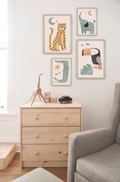 a baby's room with pictures on the wall