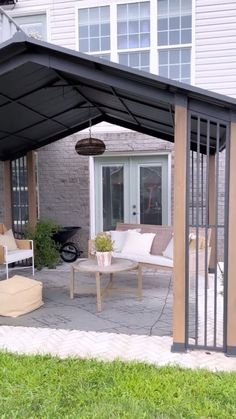 a covered patio with furniture and a table