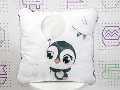 a pillow with a cartoon penguin on it