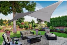 an outdoor patio with furniture and shade sail