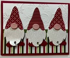 a card with three gnomes on it and one is red, white and green