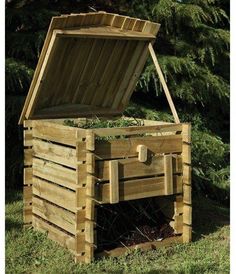 an open wooden box sitting in the grass