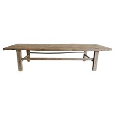 an old wooden table with two legs and a long slab on the top, against a white background