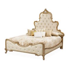 a bed with an ornate headboard and foot board, made in gold leafy fabric