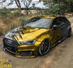 a yellow car parked on the side of a dirt road