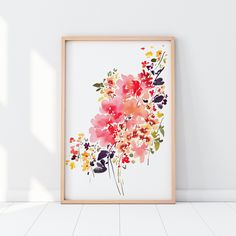 an art print in a frame on the floor next to a wall with white walls