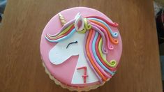 a birthday cake decorated with an unicorn's head