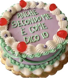 a cake that is sitting on top of a table with the words anghe second me e come dio 10