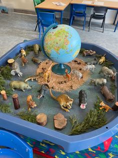 a toy table with toys in it and a globe on top